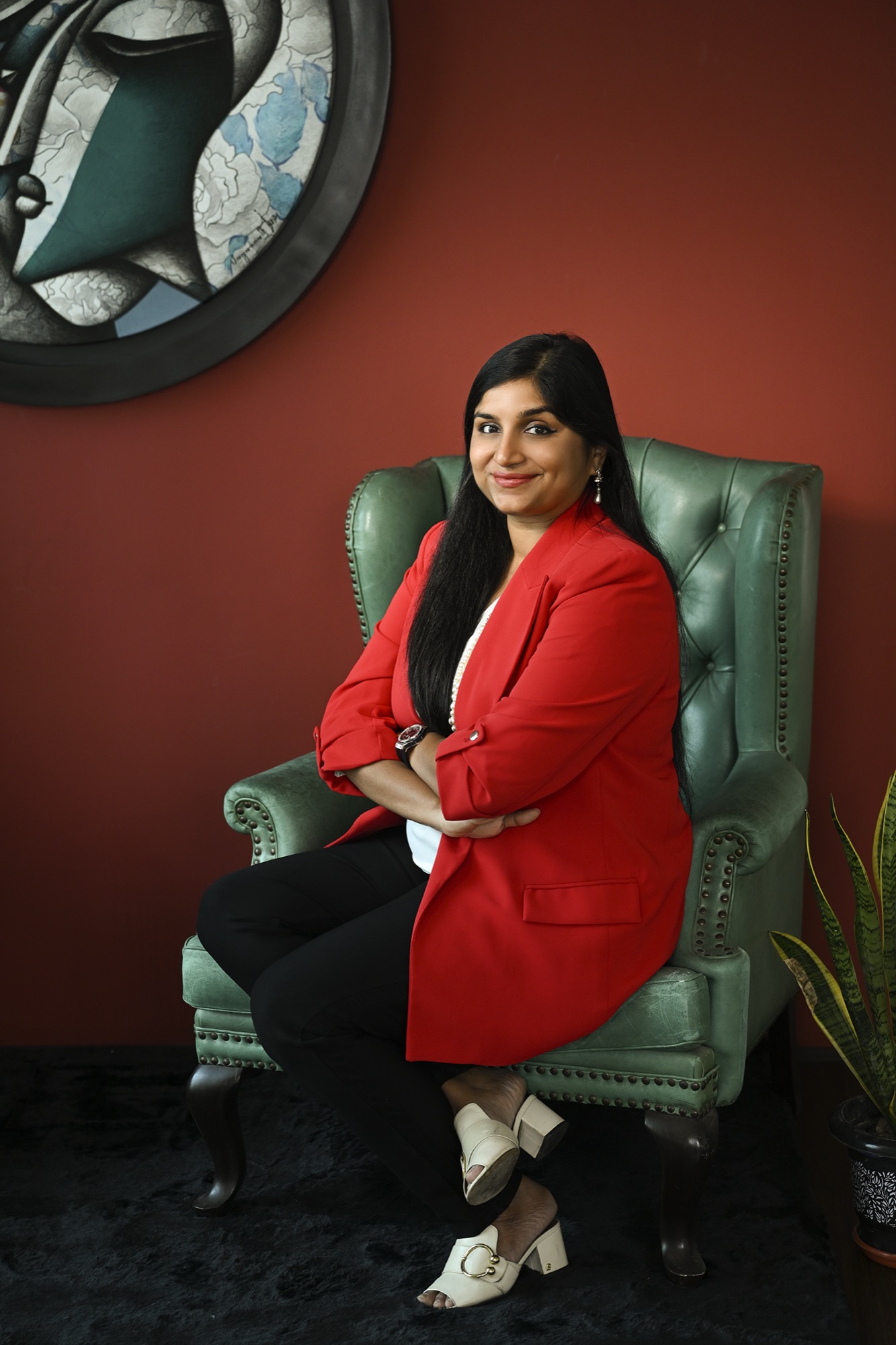 Aradhana Dalmia, founder of The Artemist, before a gallery wall of works